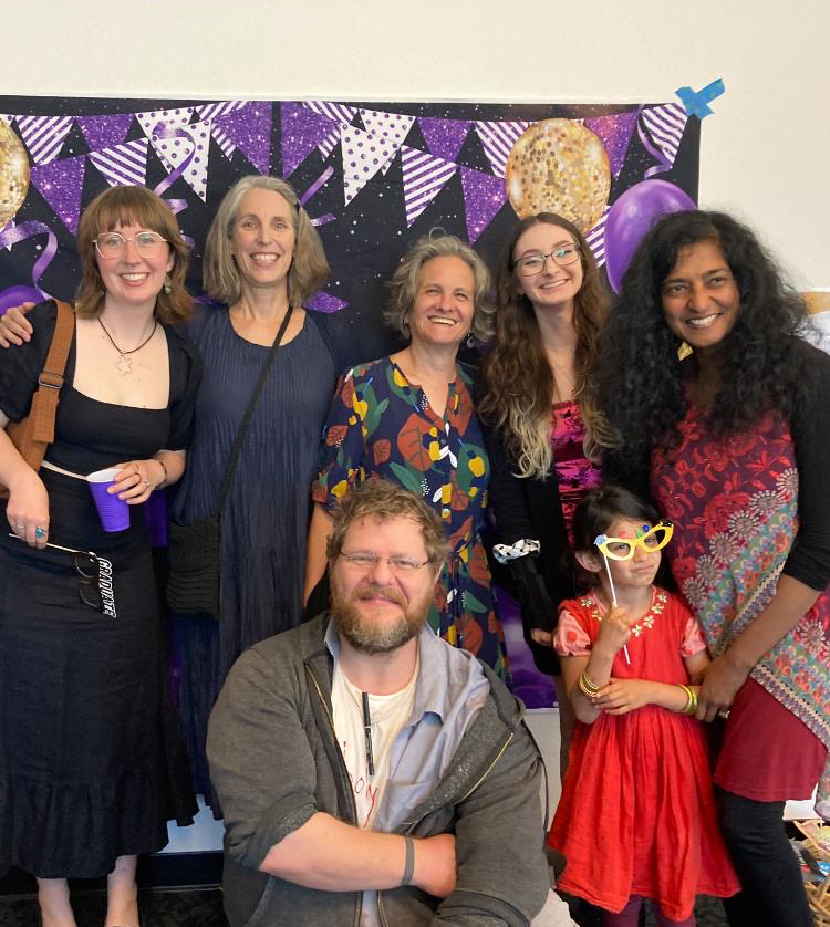 Graduates and faculty pose for a photo at the HUM/CWL grad celebration